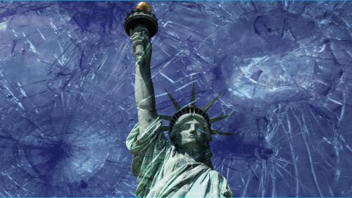 Photo of the Statue of Liberty from the torso up, with a blue sky in the background and shattered glass across the image in the foreground