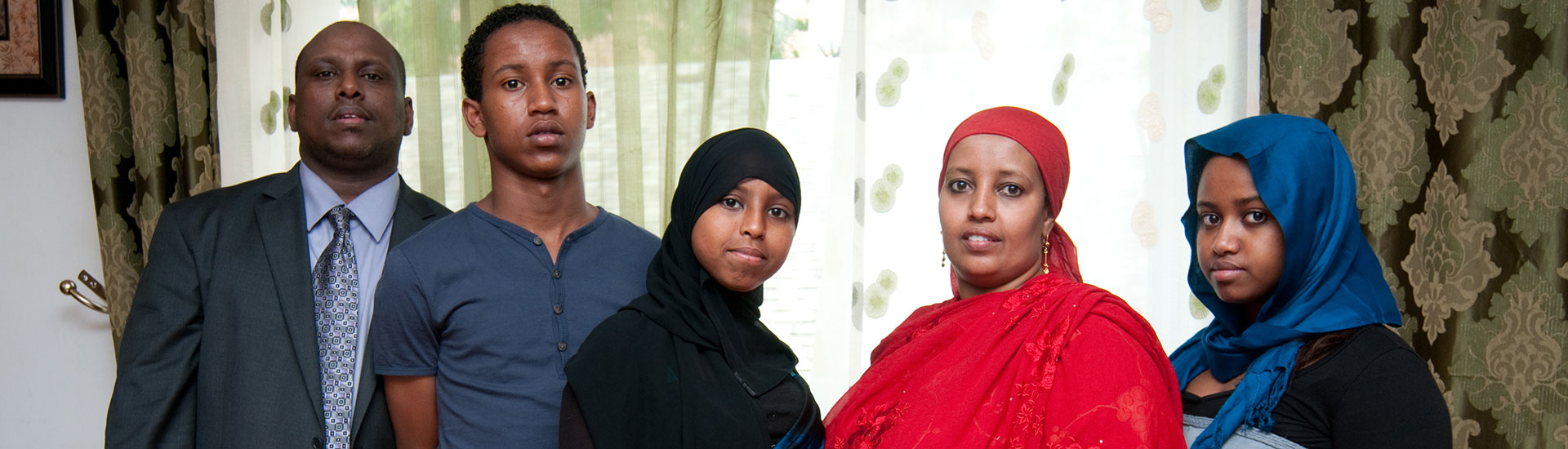 Family photo of a mother, father, and their three teenage children, who received asylum from Somalia with representation from NIJC.