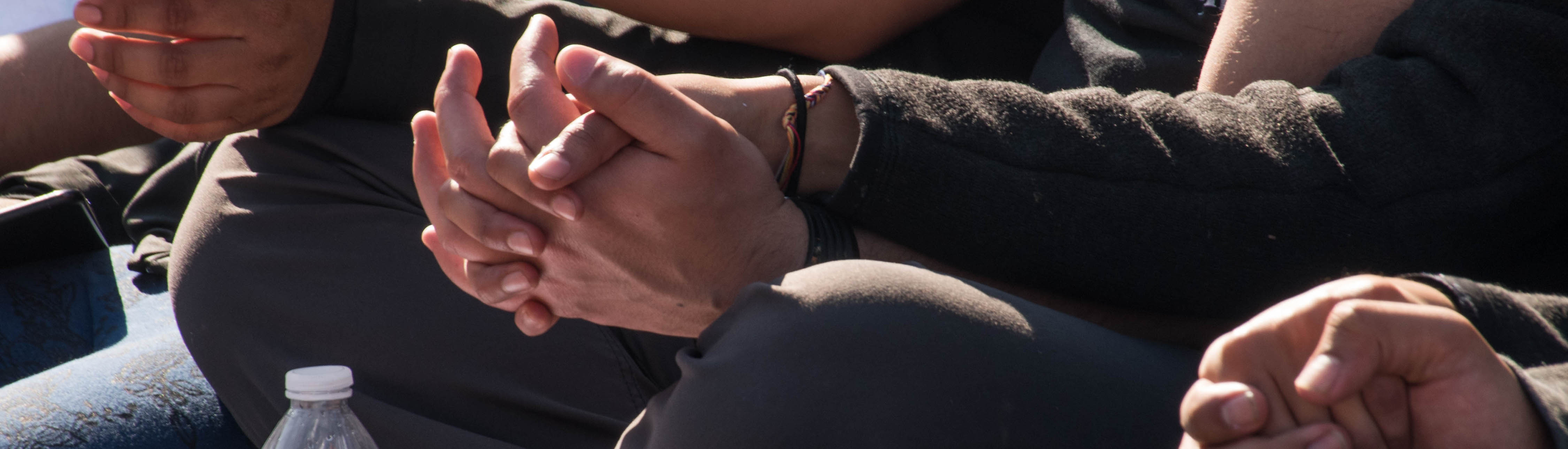 People holding hands, close up view of their hands together