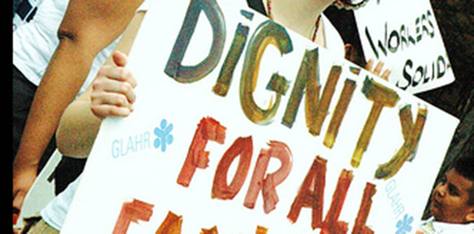 Hand-made protest sign saying "Dignity for all"