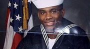 Photo of Howard Bailey in his Navy uniform, with a U.S. flag in the background