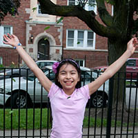 Girl with excited look on her face and arms up in the air