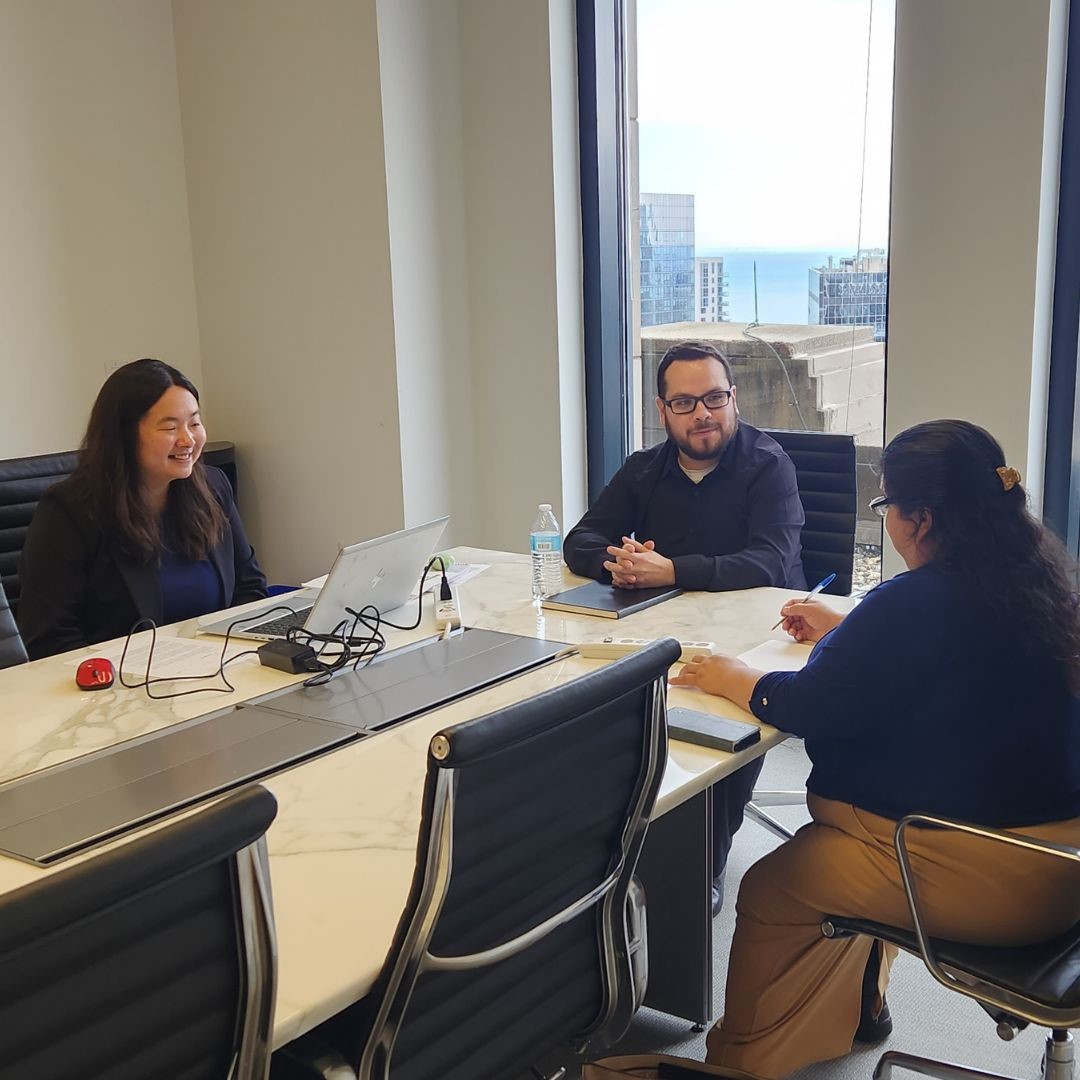 Pro bono lawyers speak with survivors of human trafficking in a law office.