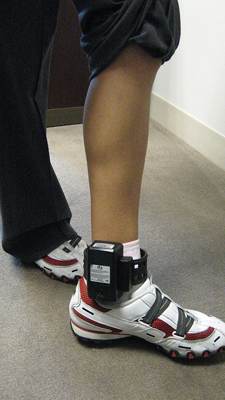 Photo of an ankle shackle on the leg of an NIJC client