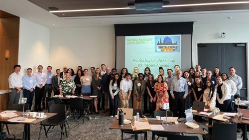 Photo of a large group of volunteer attorneys, interpreters, and NIJC staff who participated in NIJC's July 2024 Mega Asylum Clinic