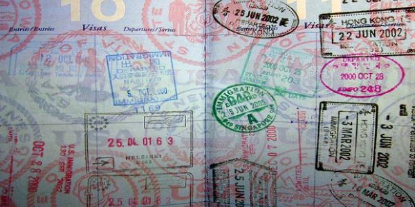 Photo of a passport page covered in colorful visa stamps.