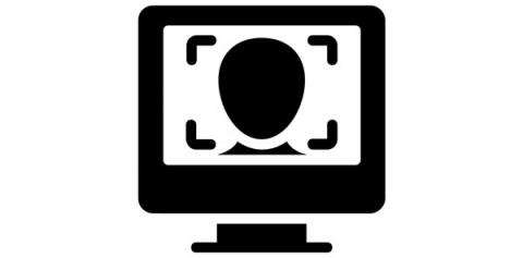 Black and white icon of a computer monitor. On the screen is an outline of a human face, surrounded by square hash lines like that used in facial recognition technology