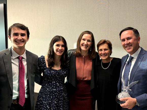 Katten Pro Bono Service Award winner Chad Dooby smiles with NIJC Executive Director Mary Meg McCarthy and his family.