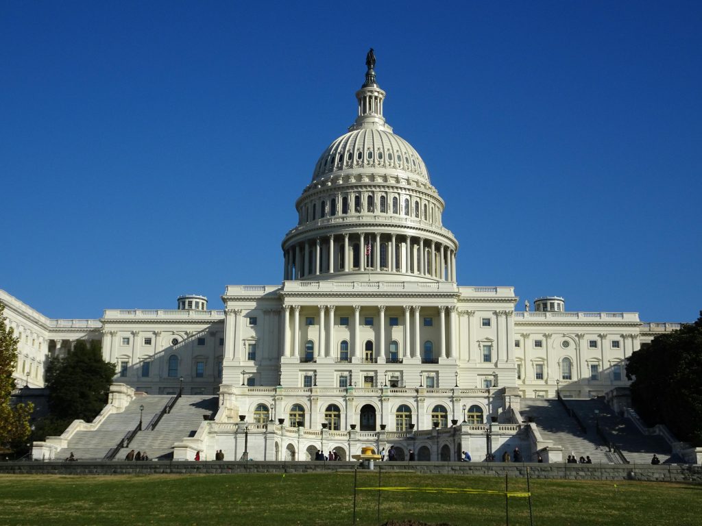 Stunning facade of the iconic United States Capitol in Washington D.C. against a clear blue sky.