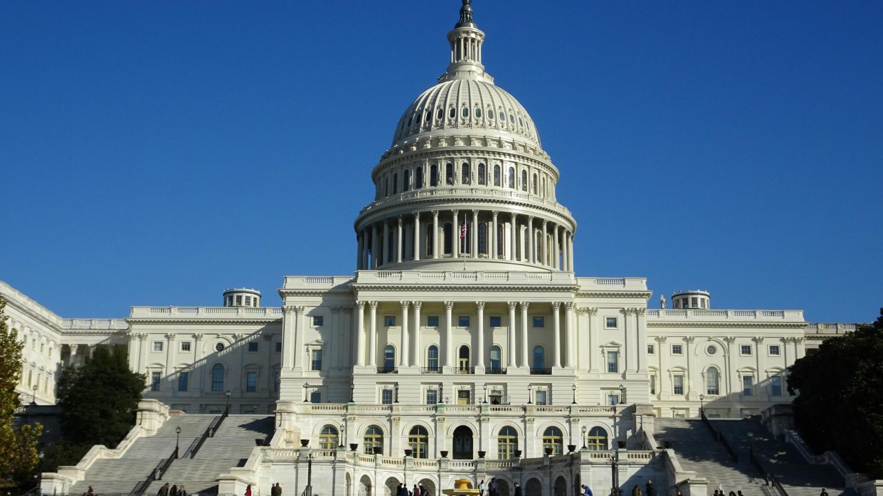 Stunning facade of the iconic United States Capitol in Washington D.C. against a clear blue sky.